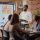 Company employee presenting business strategy with charts on monitor, planning project. Workmates analyzing financial statistics on display, working together on company development.